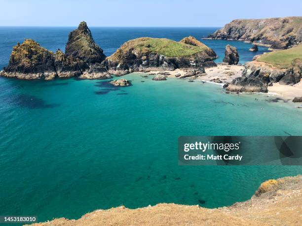 The white sand, turquoise sea and rock stacks of Kynance Cove on the Lizard Peninsula are seen on June 29, 2018 in Cornwall, England. The county of...