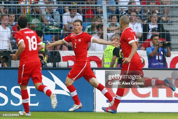 Stephan Lichtsteiner of Switzerland celebrates his team's fourth goal with team mates Eren Derdiyok and Admir Mehmedi during the international...