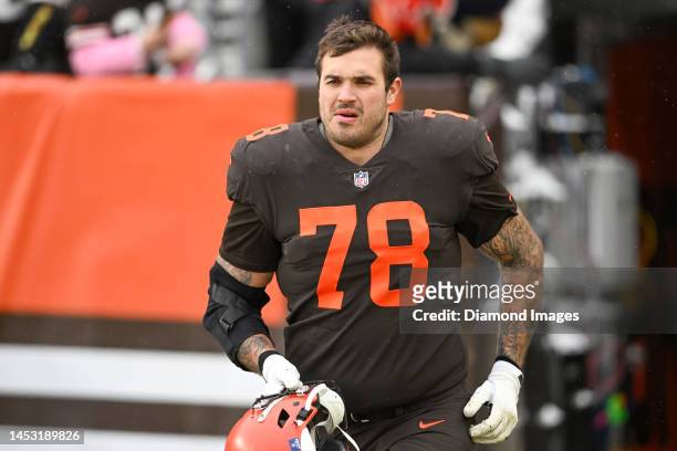 Jack Conklin of the Cleveland Browns runs onto the field at halftime against the New Orleans Saints at FirstEnergy Stadium on December 24, 2022 in...