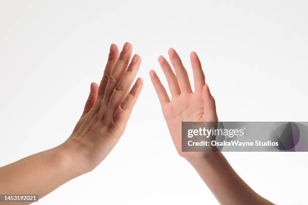 human hands interacting - high five stockfoto's en -beelden