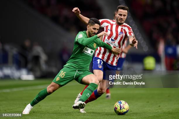 Fidel of Elche CF holds off Saul Niguez of Atletico Madrid during the LaLiga Santander match between Atletico de Madrid and Elche CF at Civitas...