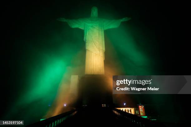 Christ the Redeemer statue is lit with the colors of the Brazilian flag to pay homage to late football legend Pelé on December 29, 2022 in Rio de...