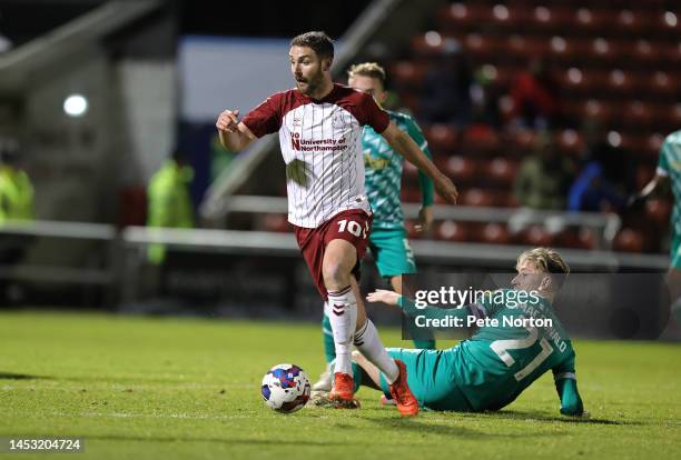 Danny Hylton of Northampton Town moves away with the ball from Angus MacDonald of Swindon Town during the Sky Bet League Two between Northampton Town...