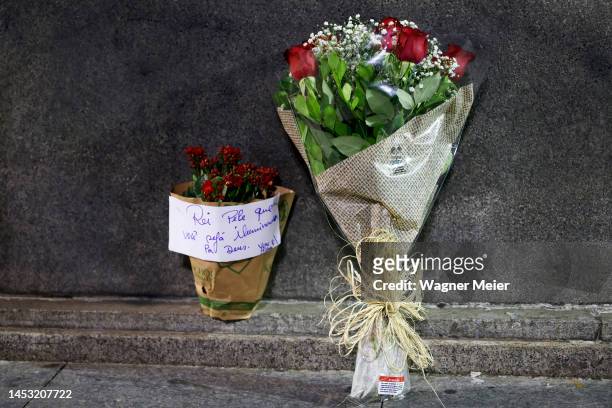 Flowers are laid for late football legend Pele at Bellini statue outside Maracana Stadium on December 29, 2022 in Rio de Janeiro, Brazil. Brazilian...