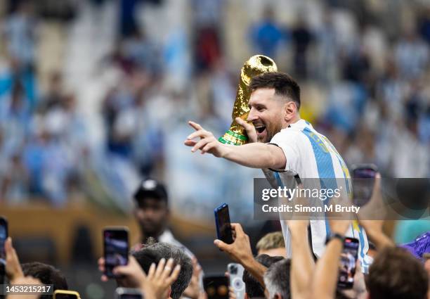 Lionel Messi of Argentina celebrates with the World Cup Trophy after the FIFA World Cup Qatar 2022 Final match between Argentina and France at Lusail...