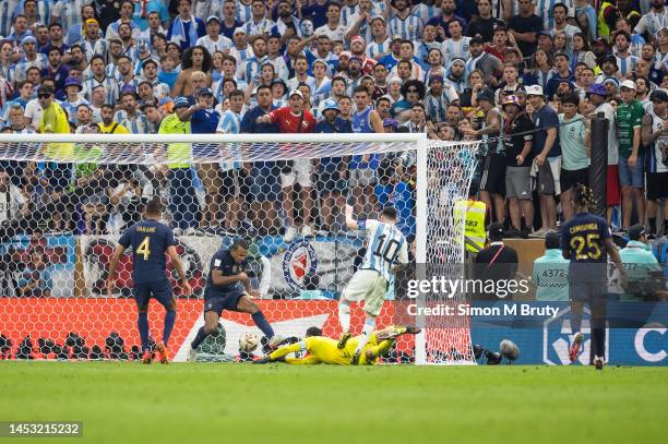 Lionel Messi of Argentina beats France goalkeeper Hugo Lloris to score a goal in extra-time to make it 3-2 during the FIFA World Cup Qatar 2022 Final...