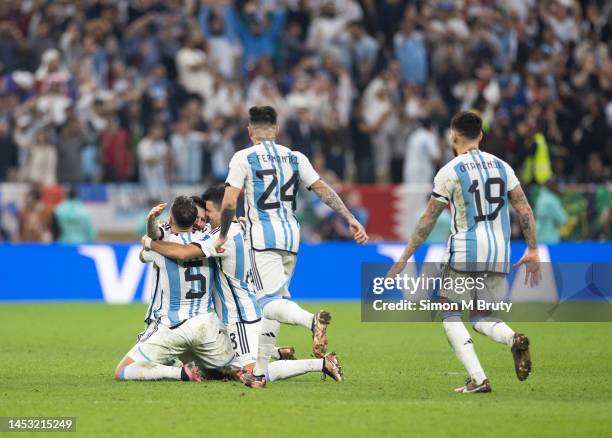 Lionel Messi, Leandro Paredes, Marcos Acuna, Enzo Fernandez and Nicolas Otamendi of Argentina celebrate their teams win during the penalty phase of...