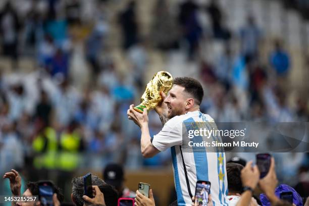 Lionel Messi of Argentina celebrates with the World Cup Trophy after the FIFA World Cup Qatar 2022 Final match between Argentina and France at Lusail...