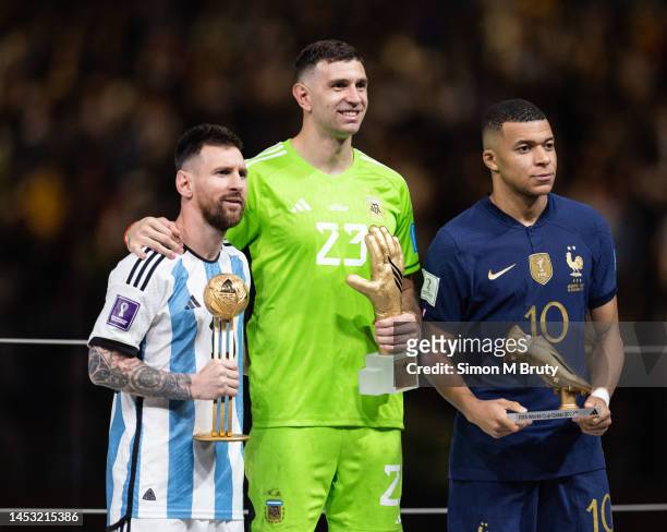 Lionel Messi of Argentina with the Golden Ball award, Emiliano Martinez with the Golden Glove award and Kylian Mbappe of France with the Golden boot...