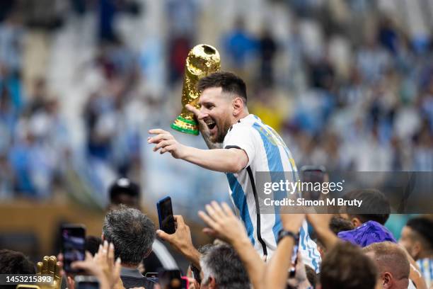 Lionel Messi of Argentina celebrates with the World Cup Trophy after the FIFA World Cup Qatar 2022 Final match between Argentina and France at Lusail...