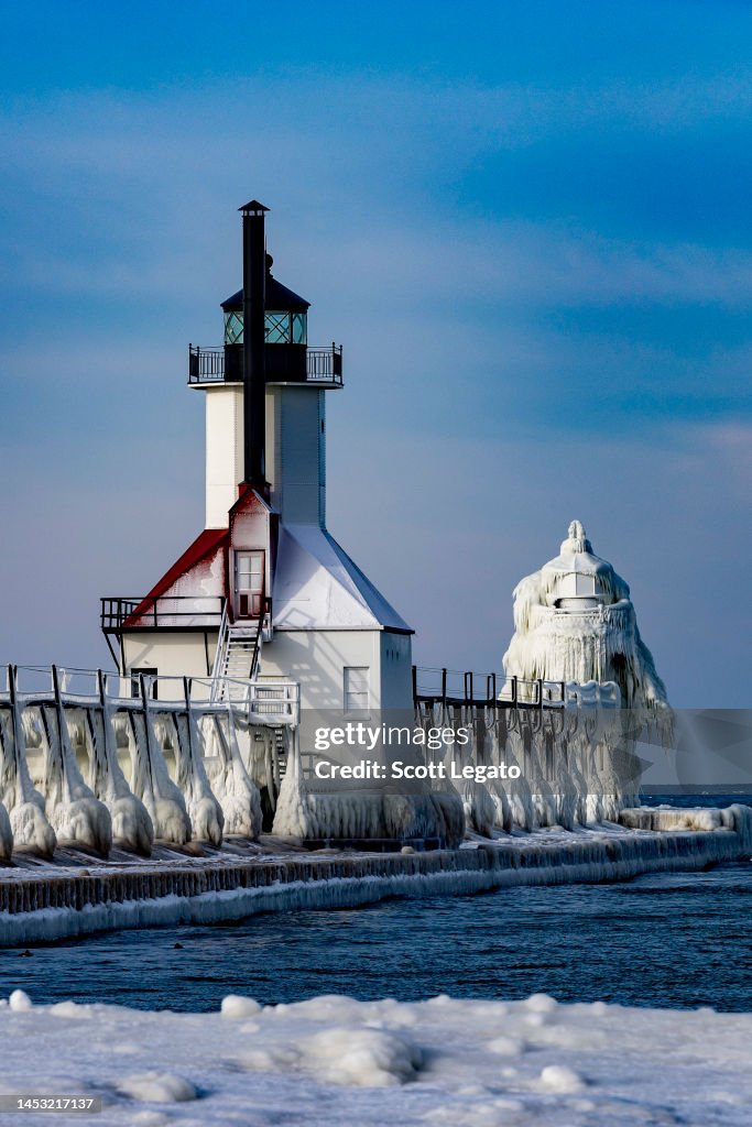 The St. Joseph Lighthouse is seen frozen over from recent frigid ...