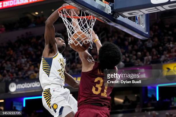Aaron Nesmith of the Indiana Pacers dunks the ball against Jarrett Allen of the Cleveland Cavaliers in the fourth quarter at Gainbridge Fieldhouse on...