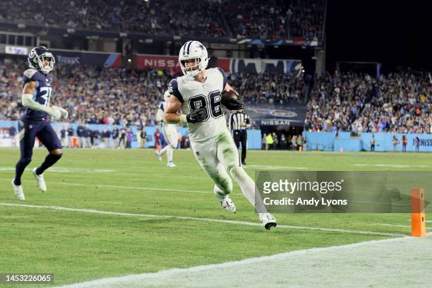 Dalton Schultz of the Dallas Cowboys scores a six yard touchdown against the Tennessee Titans during the third quarter of the game at Nissan Stadium...