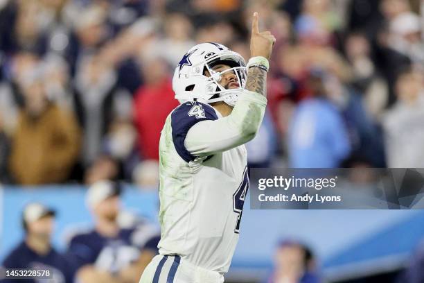 Dak Prescott of the Dallas Cowboys celebrates a touchdown scored by Dalton Schultz against the Tennessee Titans during the fourth quarter of the game...