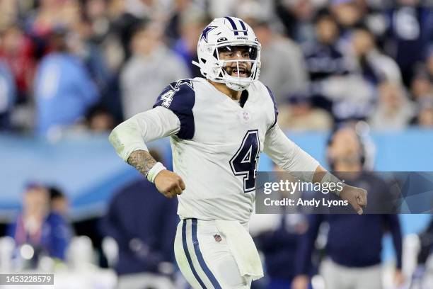 Dak Prescott of the Dallas Cowboys celebrates a touchdown scored by Dalton Schultz against the Tennessee Titans during the fourth quarter of the game...