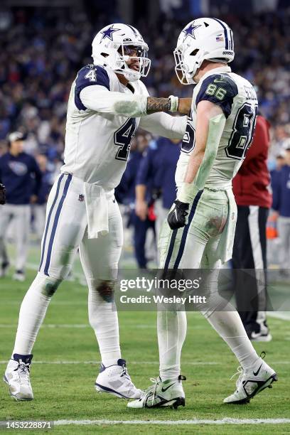 Dalton Schultz of the Dallas Cowboys celebrates with Dak Prescott after scoring a 10 yard touchdown against the Tennessee Titans during the fourth...