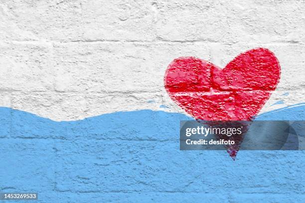 one large red colored heart shape sign or symbol at the right side floating in blue water wave of white coloured grunge textured white brick wall vector backgrounds leaving ample copy space for text - i love you stock illustrations