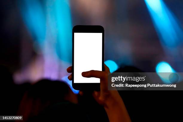 hand holding their smart phones and photographing concert - music festival phone stock pictures, royalty-free photos & images