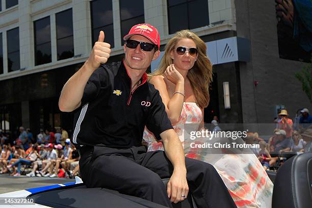 Ryan Briscoe of Australia driver of the Team Penske Dallara Chevrolet and his wife Nicole Briscoe wave to fans during the Indianapolis 500 Festival...