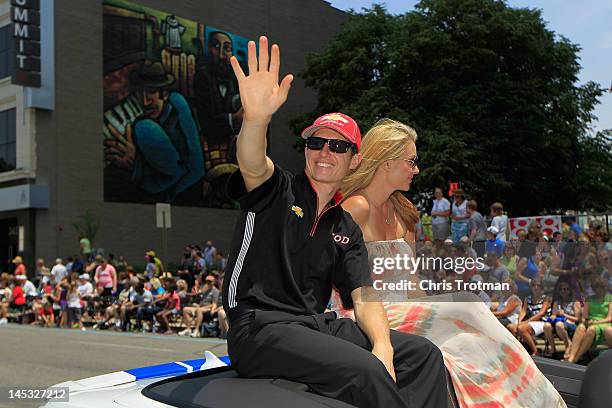 Ryan Briscoe of Australia driver of the Team Penske Dallara Chevrolet and his wife Nicole Briscoe wave to fans during the Indianapolis 500 Festival...