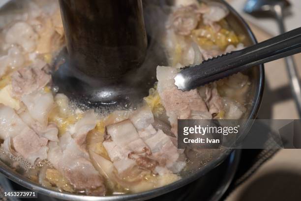 chinese cuision, meat with pickled mustard cabbage hot pot - mizutaki stockfoto's en -beelden
