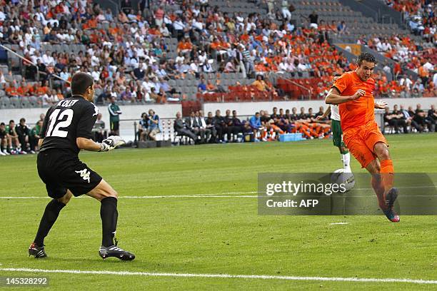 Dutch football player Robin van Persie scores the 1-0 past Bulgaria goalkeeper Stoyan Kolev during a friendly football match between the Netherlands...