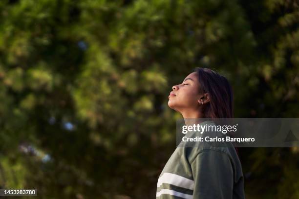 lady relaxing outdoors inhaling fresh air. - the deep stock pictures, royalty-free photos & images