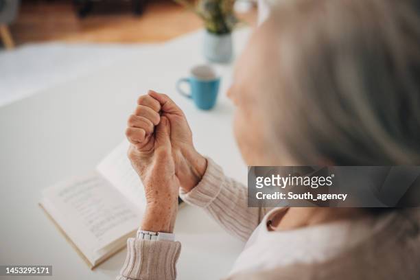 old woman has problems with hands - rheumatism stock pictures, royalty-free photos & images