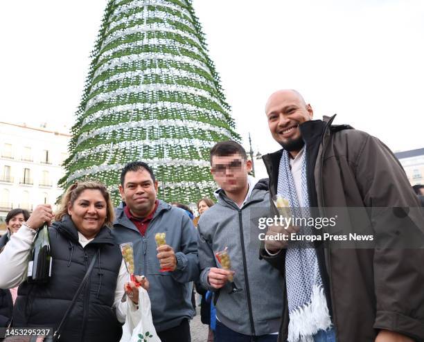 Several people pose with their grapes during the Preuvas at Puerta del Sol, on December 30 in Madrid, Spain. The Preuvas is a rehearsal for the 12...