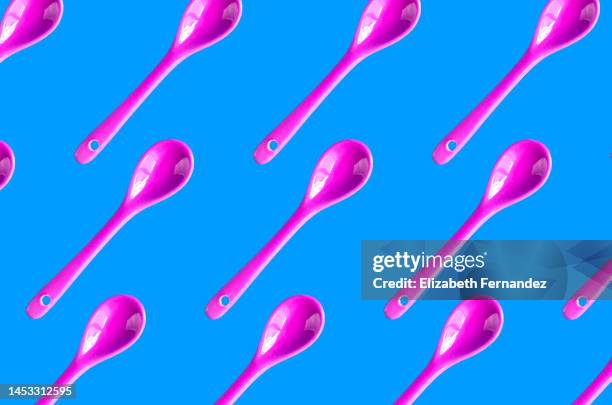 seamless pattern of pink teaspoon on blue background - cooking utensil isolated stock pictures, royalty-free photos & images