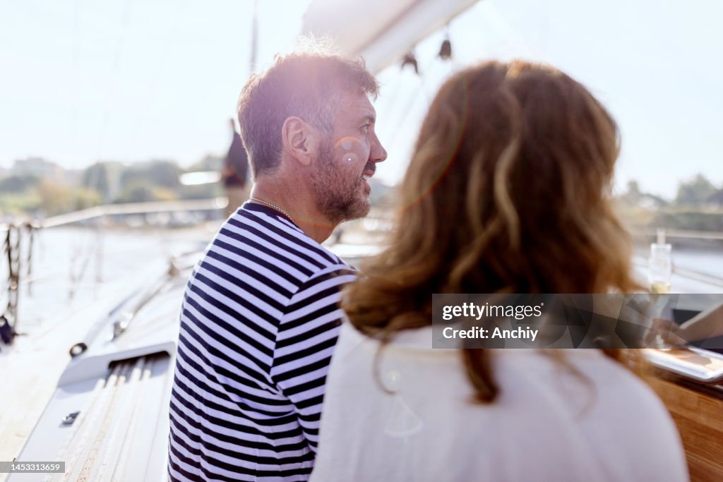 Happy friends on a yacht drinking champagne