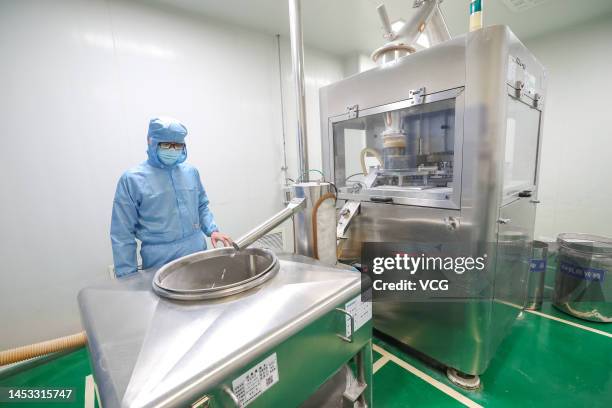 An employee works on the production line of ibuprofen, a fever reduction medicine, at a factory of Huazhong Pharmaceutical Co., Ltd on December 30,...