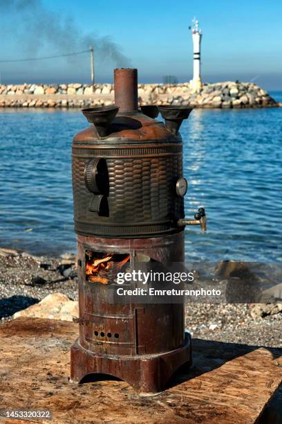 samovar near the sea on a sunny day in izmir. - samowar stock-fotos und bilder