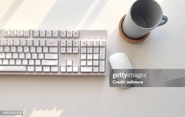 top view of computer keyboard and mouse, glass of water on desk - computer mouse table stock pictures, royalty-free photos & images