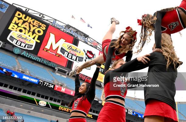 The North Carolina State Wolfpack cheerleading squad warms up prior to the Duke's Mayo Bowl game against the Maryland Terrapins at Bank of America...