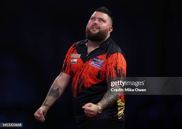 Michael Smith of England celebrates winning his Fourth Round match against Joe Cullen of England during Day Eleven of The Cazoo World Darts...