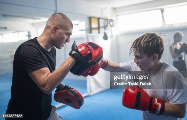 group of kids practicing with instructor boxing at gym - fighting ring bildbanksfoton och bilder