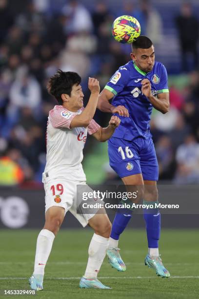 Angel Algobia of Getafe CF competes for the ball with Kang In Lee of RCD Mallorca during the LaLiga Santander match between Getafe CF and RCD...