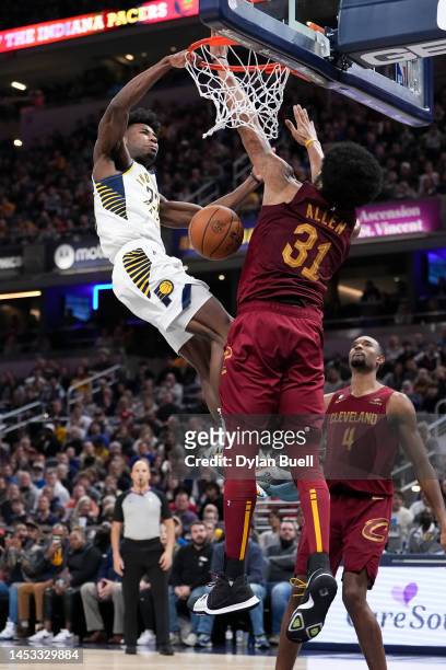 Aaron Nesmith of the Indiana Pacers dunks the ball over Jarrett Allen of the Cleveland Cavaliers in the fourth quarter at Gainbridge Fieldhouse on...