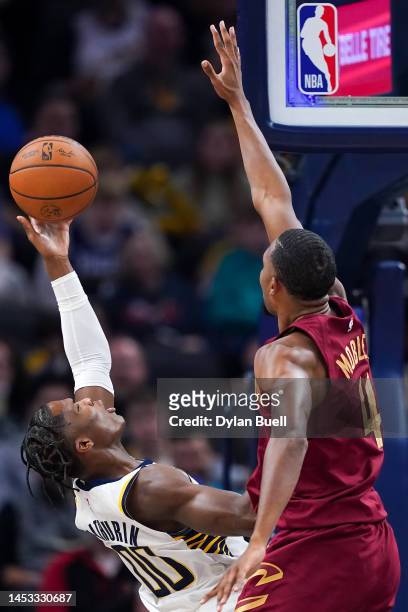 Bennedict Mathurin of the Indiana Pacers attempts a shot while being guarded by Evan Mobley of the Cleveland Cavaliers in the first quarter at...
