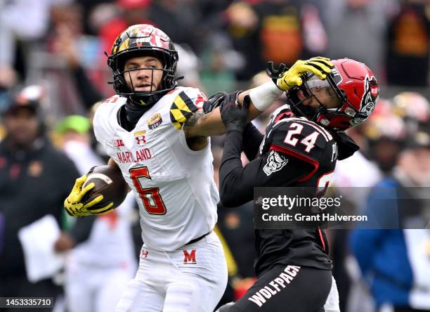 Jeshaun Jones of the Maryland Terrapins stiff-arms Derrek Pitts Jr. #24 of the North Carolina State Wolfpack during the first half of the Duke's Mayo...