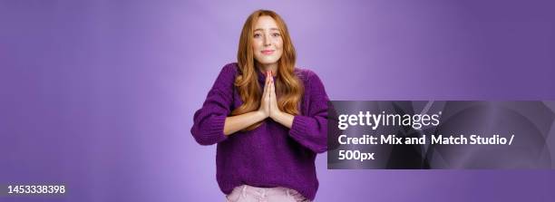 charming cute redhead woman with long hair and freckles in purple - perdão imagens e fotografias de stock
