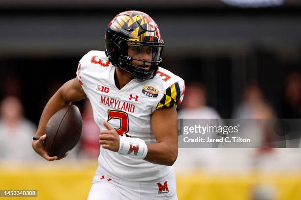 Taulia Tagovailoa of the Maryland Terrapins carries the ball for yardage during the first half of the Duke's Mayo Bowl against the North Carolina...