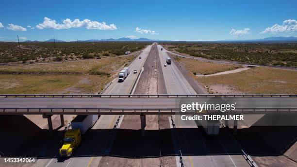 semi-trucks driving on a interstate 10 in texas, usa - aerial view - interstate 10 stock pictures, royalty-free photos & images