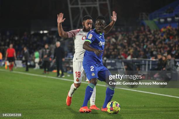 Djene Dakonam Ortega of Getafe CF competes for the ball with Jaume Costa of RCD Mallorca during the LaLiga Santander match between Getafe CF and RCD...