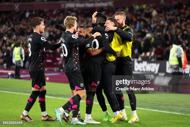 Josh Dasilva of Brentford celebrates with teammates after scoring their side's second goal during the Premier League match between West Ham United...