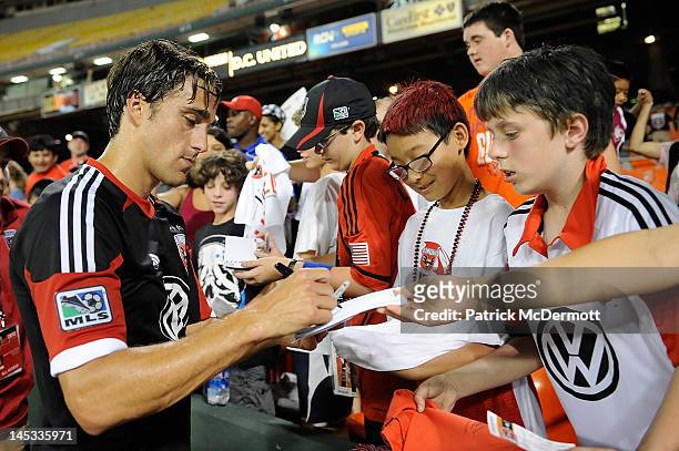 Josh Wolff of D.C. United signs autographs after a game against the New England Revolution at RFK Stadium on May 26, 2012 in Washington, DC.