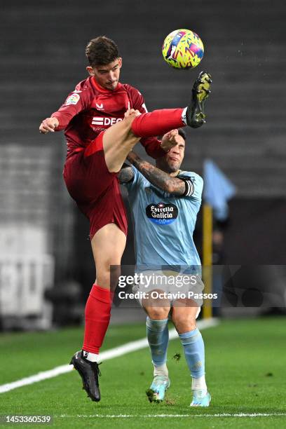 Kike Salas of Sevilla FC and Hugo Mallo of Celta Vigo battle for possession during the LaLiga Santander match between RC Celta and Sevilla FC at...