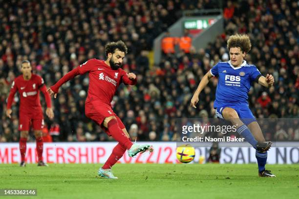Mohamed Salah of Liverpool takes a shot whilst under pressure from Wout Faes of Leicester City during the Premier League match between Liverpool FC...