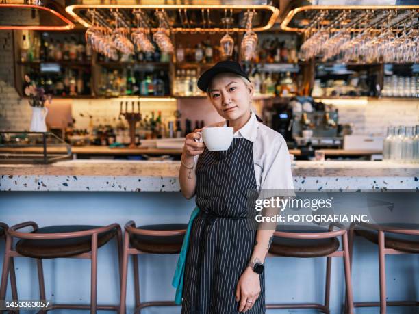 young korean female chef having morning coffee at work - chef portrait stock pictures, royalty-free photos & images